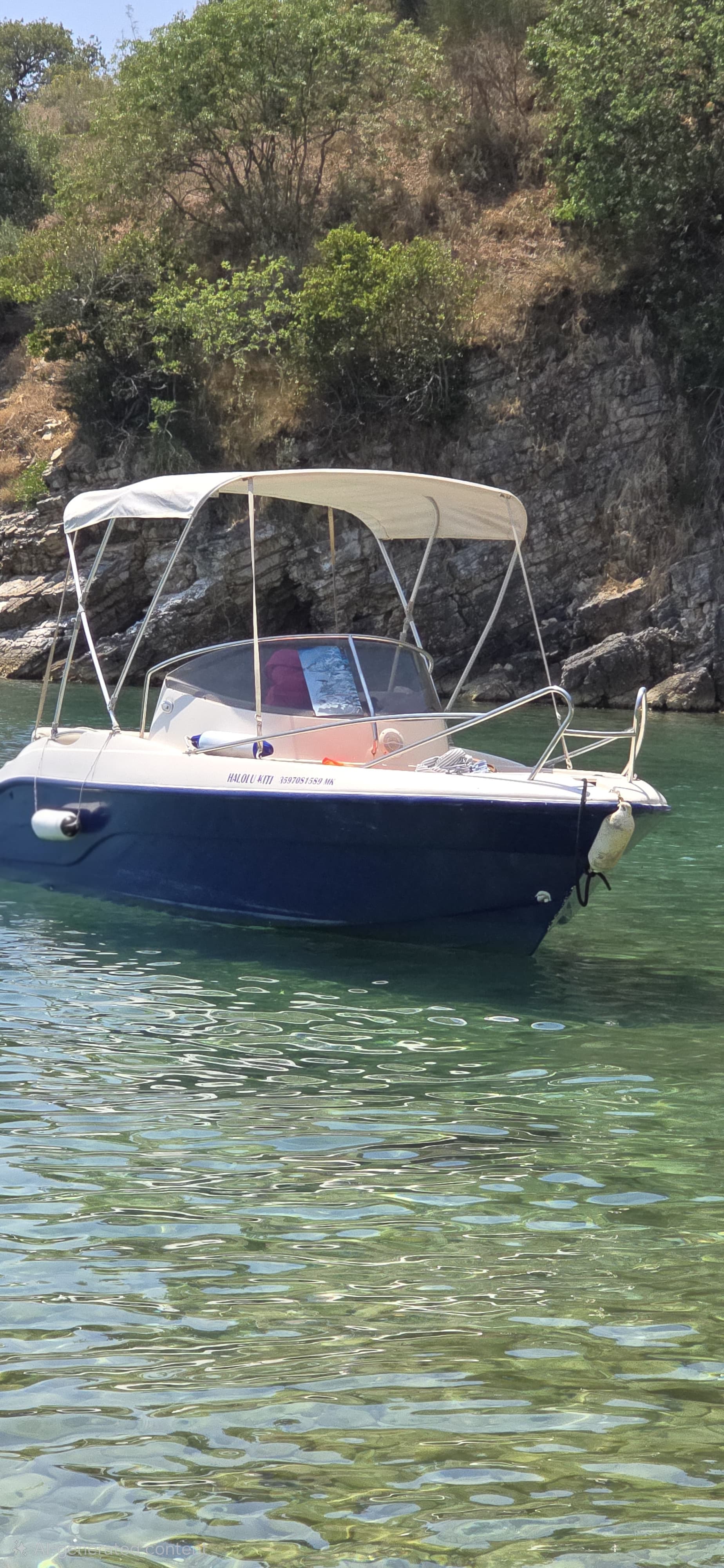 Halolu Kiti 70HP boat with sun tent extended in near Ksamil water